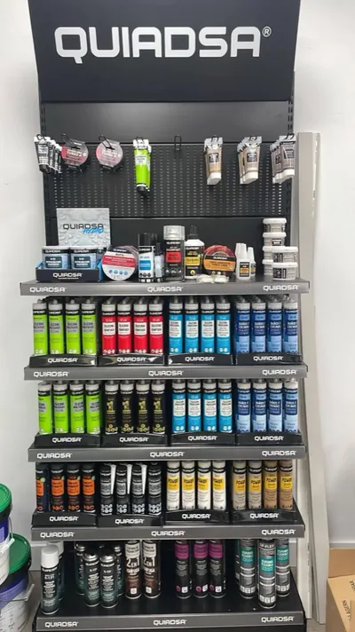 Rows of Quiadsa silicone and adhesive cartridges on the shelf.
