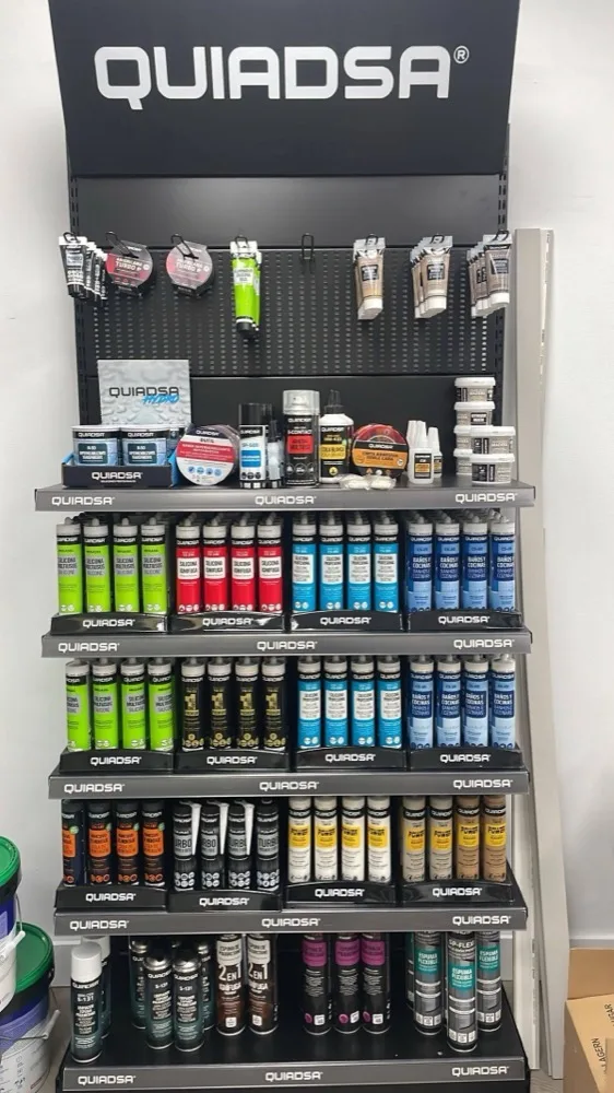 A Quiadsa gondola stacked with silicones, sealants and adhesives in every colour.