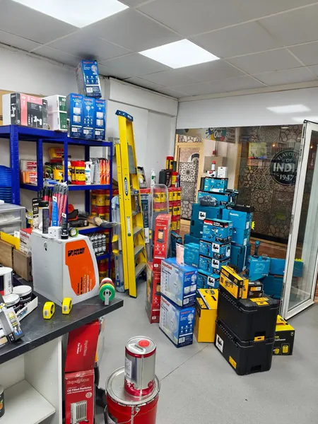 Blue racking in the Splash Out stockroom, loaded with boxed tools and tubs of Wonder Wipes.